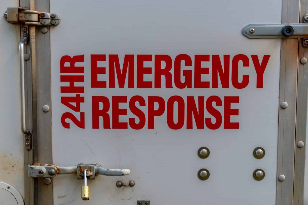 24-hour emergency response text on side of rescue roofing vehicle